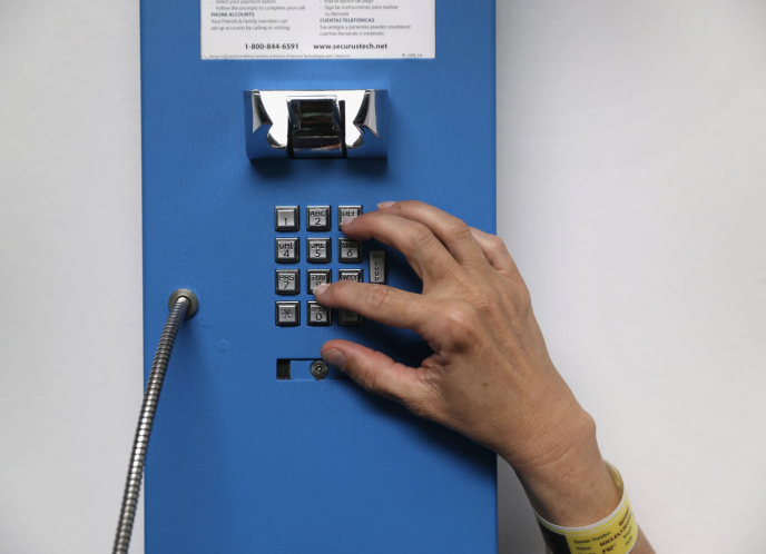 A prisoner makes one of her daily allotment of six phone calls at the York Community Reintegration Center on May 24, 2016, in Niantic, Connecticut.