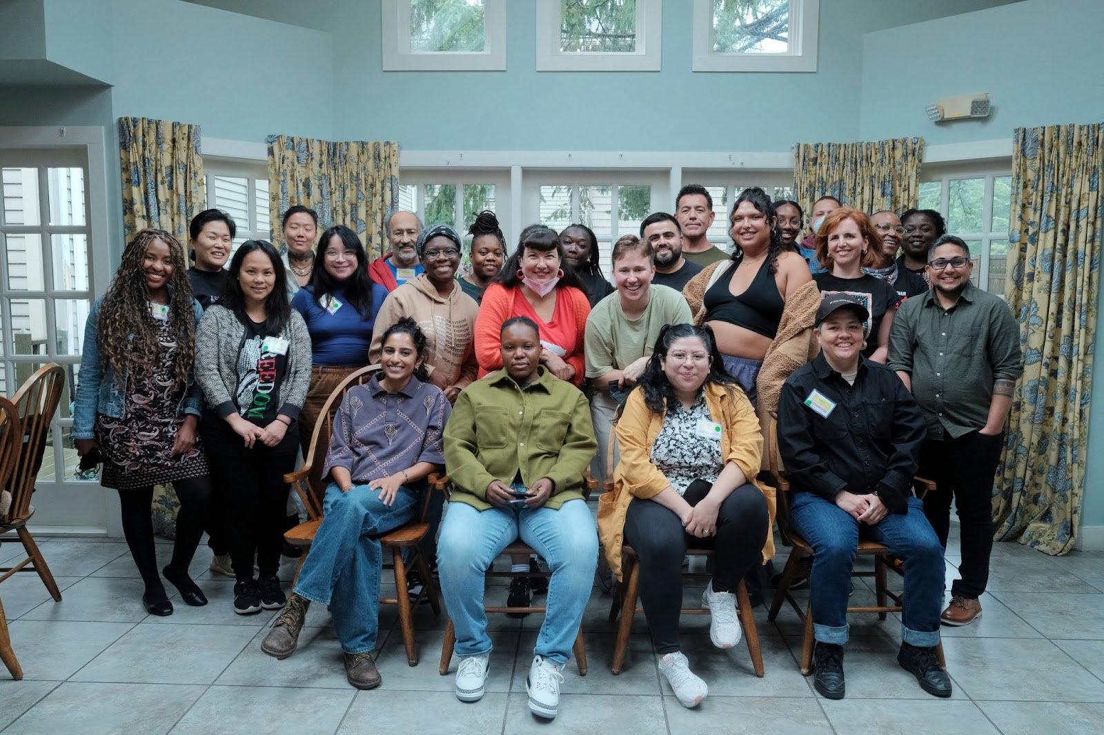 The MediaJustice NEtwork Fellows, Alumni, Mentors, and Staff smile at the camera in a group photo